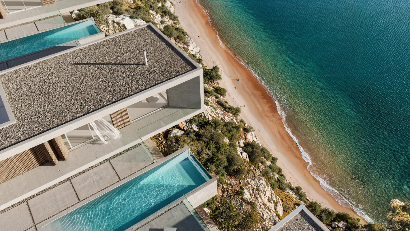 An aerial view of The Edge, an exclusive seafront residential complex on the cliffs of North Cyprus. The modern, minimalist villas feature flat gravel roofs and private cantilevered infinity pools that extend toward a secluded sandy beach and the turquoise Mediterranean Sea. The architectural design seamlessly blends with the rugged coastal landscape, offering a sense of extreme privacy and luxury.