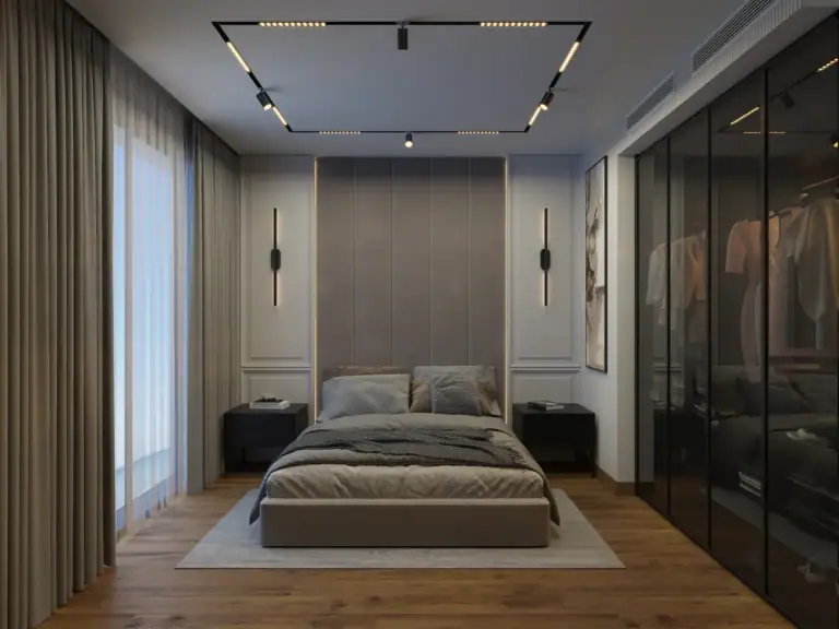 Apartment bedroom with a tall beige headboard, dark glass wardrobe, and modern track lighting in Esentepe, North Cyprus.