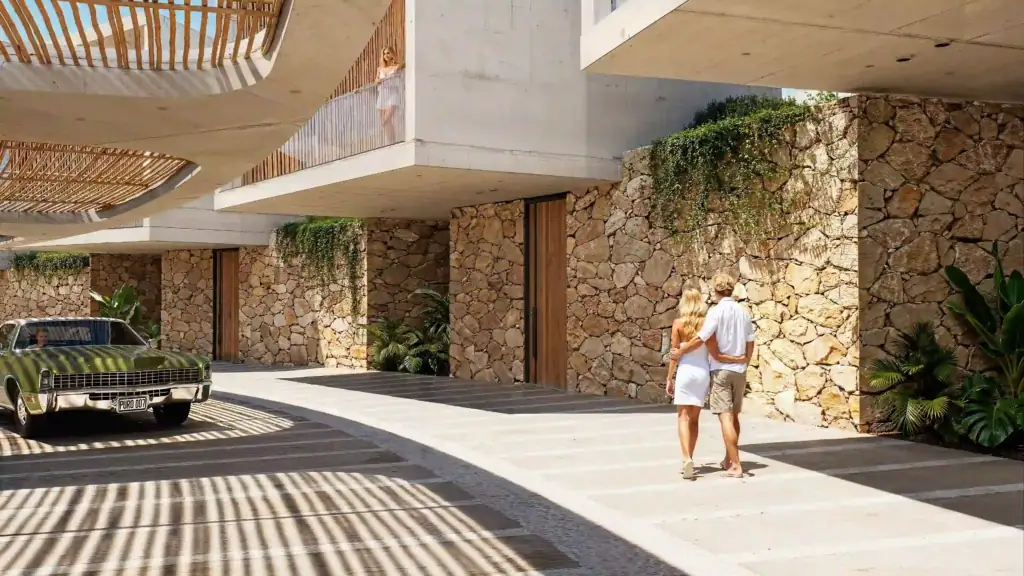 Contemporary apartment complex in North Cyprus featuring stone walls, greenery, and modern architecture.