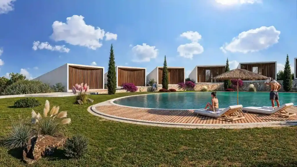 Luxury swimming pool with sun loungers and garden views in North Cyprus development.