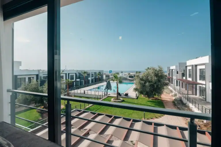 Bright apartment overlooking communal pool and green spaces in a residential development in North Cyprus.