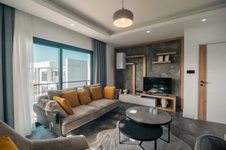 Spacious living room featuring a large window, contemporary furniture, and elegant interior design in North Cyprus.