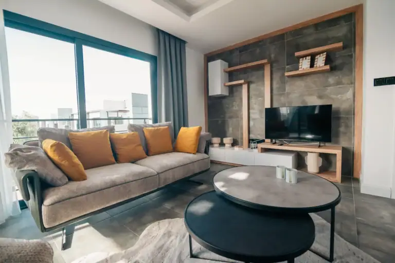 Spacious living room featuring a large window, contemporary furniture, and elegant interior design in a North Cyprus property.