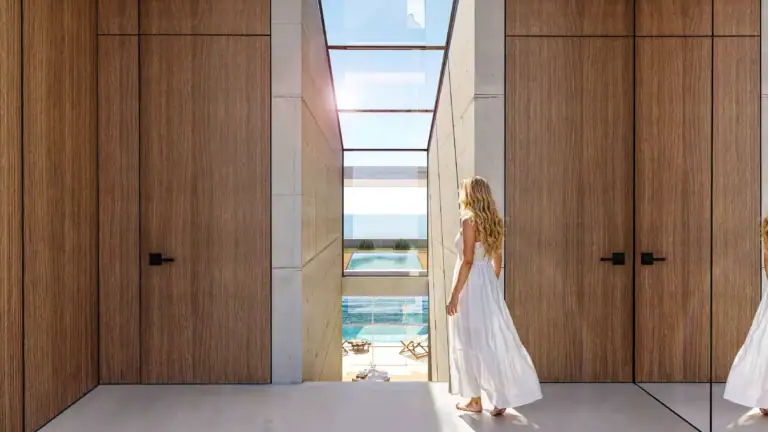 Interior view of a contemporary property with expansive glass windows and wooden wall panels in North Cyprus.