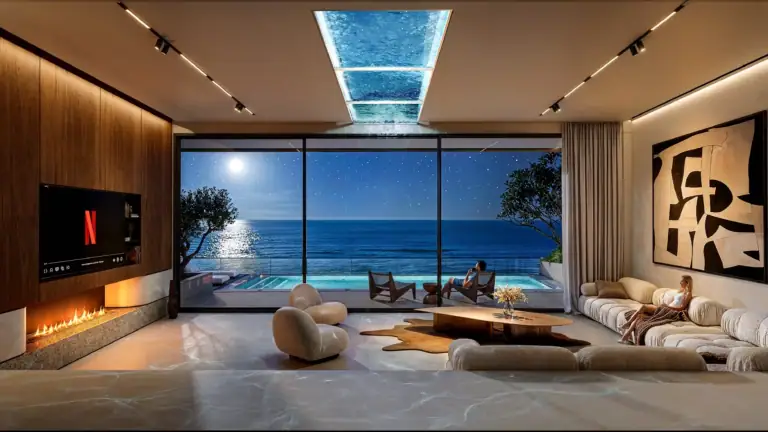 Modern living room with panoramic ocean view, stylish furniture, and large glass windows overlooking the Mediterranean Sea.