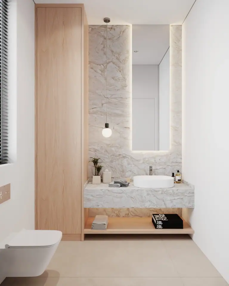 Modern minimalist bathroom featuring a floating marble vanity, tall wooden cabinets, backlit vertical mirror, and ambient hanging light.