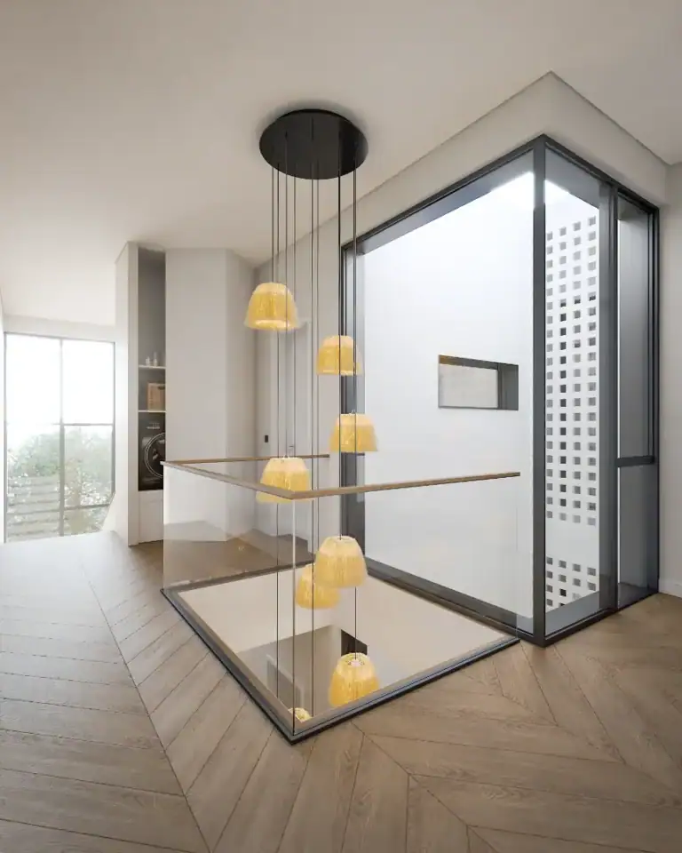 Elegant staircase with glass balustrade and hanging pendant lights in a stylish modern interior.