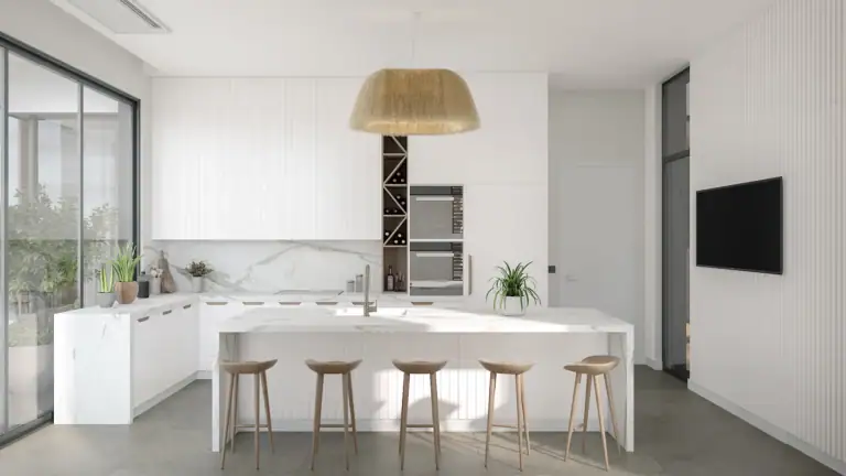 Bright and spacious modern kitchen featuring white cabinets, marble countertops, and a central island with four wooden stools.