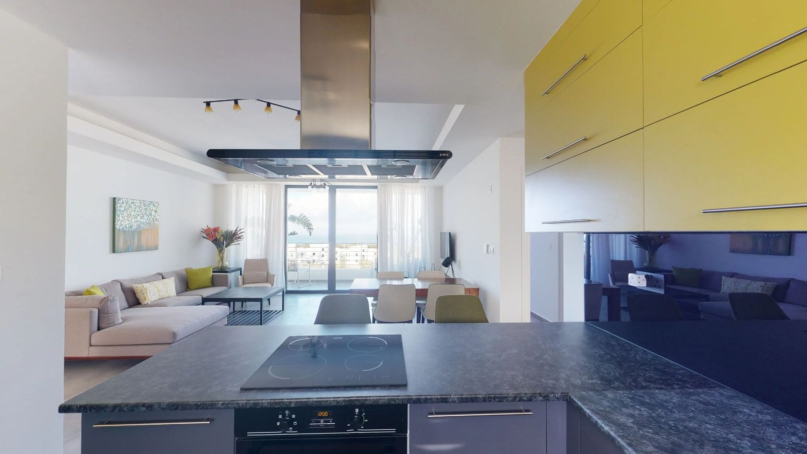 Modern open-plan living room with large windows and sea view in North Cyprus property.